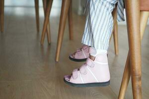 Child cerebral palsy disability, legs orthosis. photo