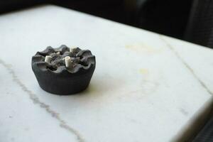 Close up burning cigarette in ashtray on table photo