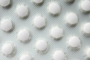 Close up of pills of blister pack on table photo