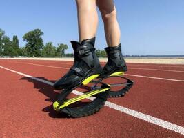 formación kango saltando en naturaleza. piernas de un niña en saltando zapatos. cardio ejercicio. sano estilo de vida concepto. cubrir para un sitio web, un Deportes club. foto