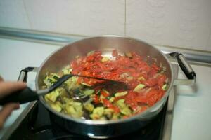 Unrecognizable person cooking vegetables photo