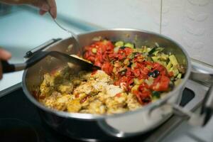 Unrecognizable person cooking vegetables photo