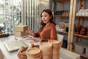 Vase brand owner processes online orders. Response to customer queries and concerns about products and shipment to increase long term loyalty and satisfaction. Routine work of e commerce entrepreneur photo