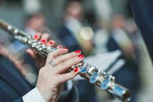 Detail of woman's hands playing transverse flute photo