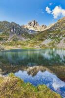 Vertical mountain landscape with lake and mountain reflection photo