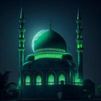 Photo a large mosque with a green light in the dark