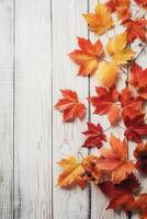 Beautiful foliage, autumn mood, the foliage lies on a white wooden table. photo