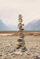 A minimalist Inukshuk made of piled stones pointing the way across the Alaskan tundra. photo