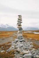 A minimalist Inukshuk made of piled stones pointing the way across the Alaskan tundra. AI generative photo