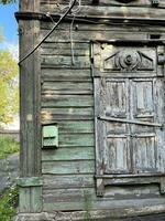 Dilapidated wooden house in a state of disrepair, still inhabited by people, Irkutsk, Russia photo
