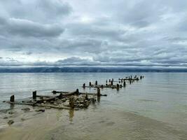 Old ruined pier on the shore of Lake Baikal, Olkhon, Russia photo