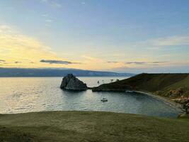 Rock Shamanka on Olkhon Island at sunset, Lake Baikal, Russia photo