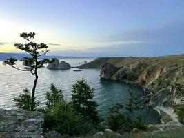 Rock Shamanka on Olkhon Island at sunset, Lake Baikal, Russia photo