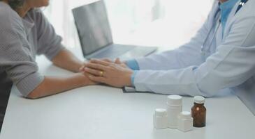 Mature Asian male doctor talking with his patient, explaining the procedure to old lady. photo