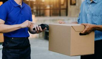 Entrepreneurs Small Business SME Independent men work at home Use smartphones and laptops for commercial checking, online marketing, packing boxes, SME sellers, concept, e-commerce team, online sales photo