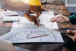 Architect having a meeting with construction team on site photo