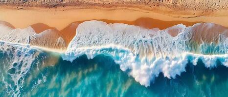 Capture the breathtaking sight of crashing waves on the shoreline with an overhead photo. Immerse yourself in the beauty of tropical beach surf and indulge in the abstract aerial view of the ocean. photo