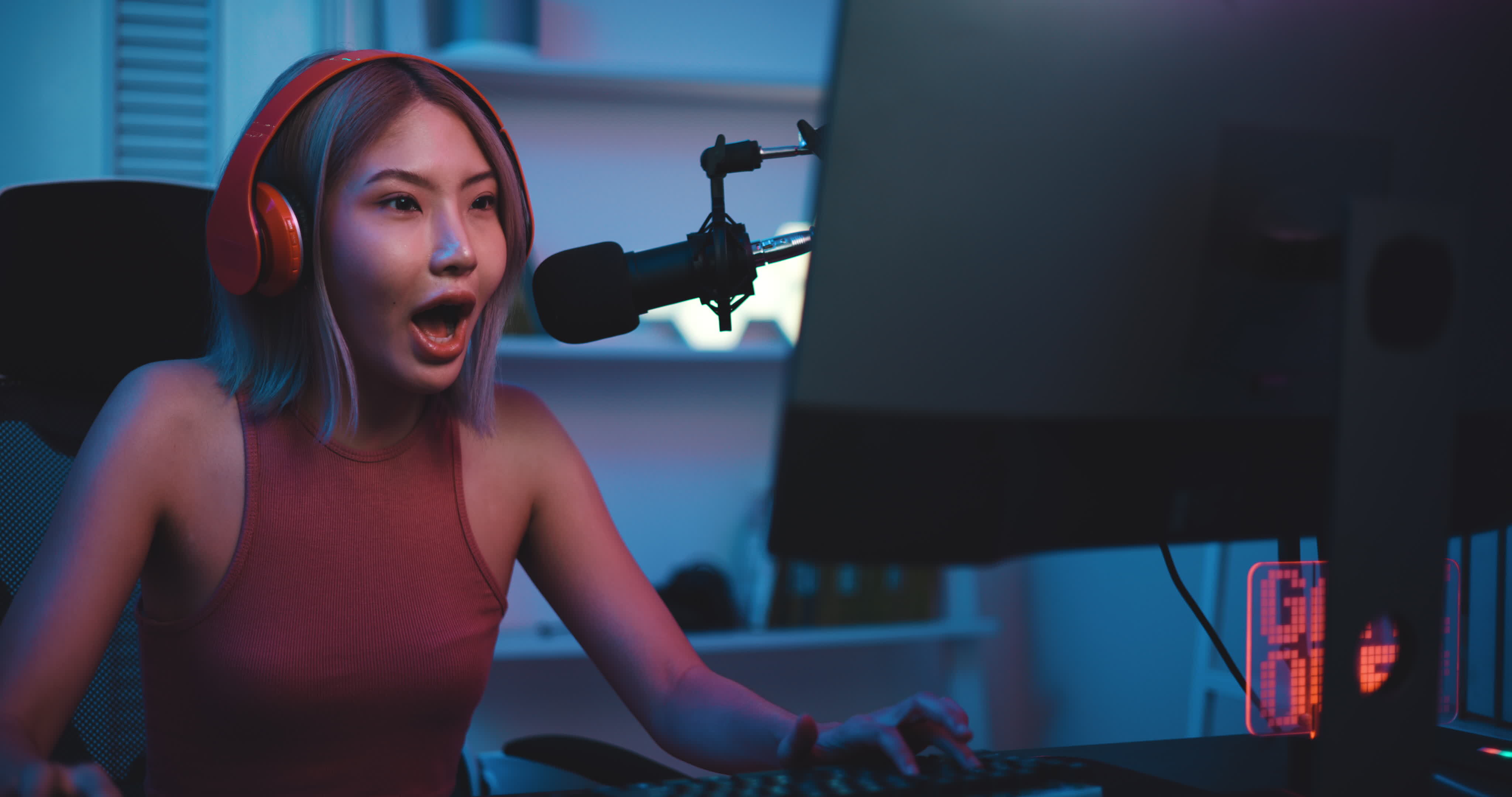 Footage of Young Asian esport woman gamers playing online video games on  the computer with neon light at home. Attractive girl gaming player feels  enjoy technology broadcast live streaming. 25213471 Stock Video