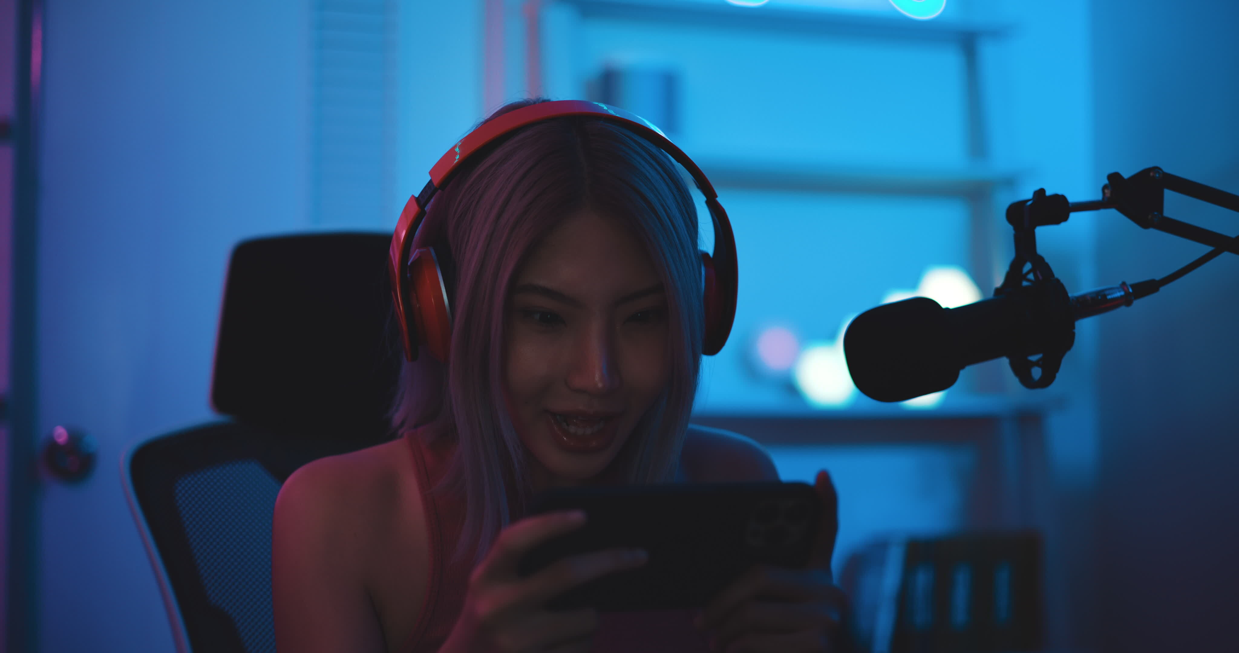 Footage of Young Asian esport woman gamers playing online video games on  the computer with neon light at home. Attractive girl gaming player feels  enjoy technology broadcast live streaming. 25213471 Stock Video