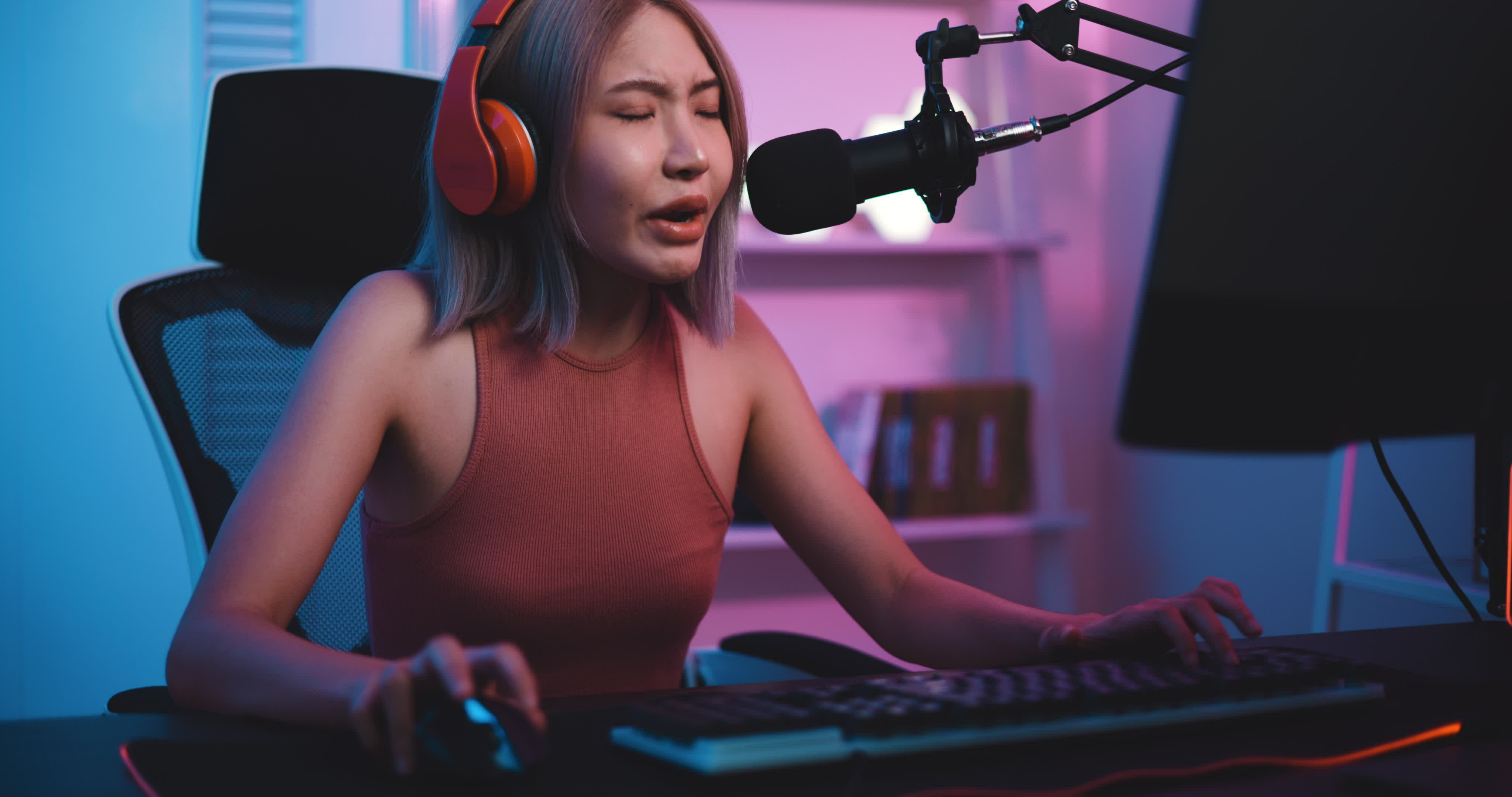 Footage of Young Asian esport woman gamers playing online video games on  the computer with neon light at home. Attractive girl gaming player feels  enjoy technology broadcast live streaming. 25213471 Stock Video