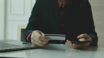 Women holding credit card and using smartphones at home.Online shopping, internet banking, store online, payment, spending money, e-commerce payment at the store, credit card, concept video