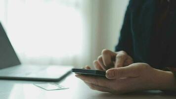 Women holding credit card and using smartphones at home.Online shopping, internet banking, store online, payment, spending money, e-commerce payment at the store, credit card, concept video