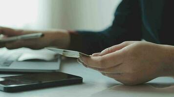 Women holding credit card and using smartphones at home.Online shopping, internet banking, store online, payment, spending money, e-commerce payment at the store, credit card, concept video