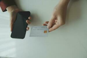 Woman hands holding and using cradit card for shopping online. photo