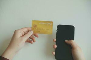 Woman hands holding and using cradit card for shopping online. photo