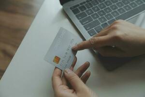 Woman hands holding and using cradit card for shopping online. photo