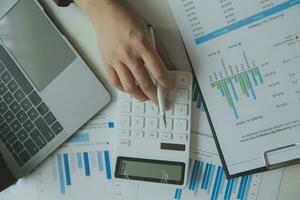 Unrecognizable businessman using calculator photo