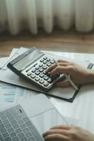 Businessmen are calculating income-expenditure and analyzing real estate investment data, Accounting Financial and tax systems concept. photo