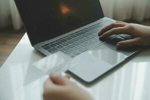 Woman hands holding and using cradit card for shopping online. photo