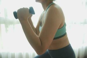 Profile Shot of a Beautiful Confident Strong Fitness Female in a Grey Athletic Outfit Doing Mountain Climber Exercises in Her Bright and Spacious Apartment with Cozy Minimalistic Interior. photo