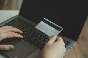 Woman hands holding and using cradit card for shopping online. photo