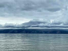 Heavy gray clouds over Baikal Lake, Olkhon island, Russia photo