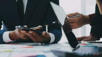 Financial analysts analyze business financial reports on a digital tablet planning investment project during a discussion at a meeting of corporate showing the results of their successful teamwork. video