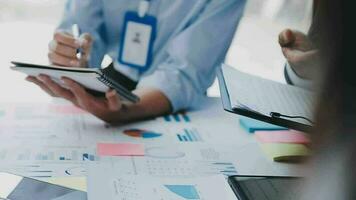 Financial analysts analyze business financial reports on a digital tablet planning investment project during a discussion at a meeting of corporate showing the results of their successful teamwork. video