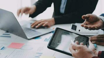 Financial analysts analyze business financial reports on a digital tablet planning investment project during a discussion at a meeting of corporate showing the results of their successful teamwork. video
