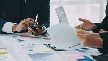 Financial analysts analyze business financial reports on a digital tablet planning investment project during a discussion at a meeting of corporate showing the results of their successful teamwork. video