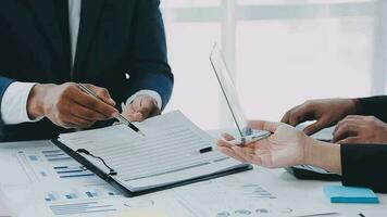 Financial analysts analyze business financial reports on a digital tablet planning investment project during a discussion at a meeting of corporate showing the results of their successful teamwork. video
