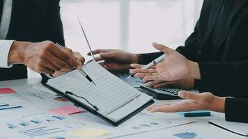 Financial analysts analyze business financial reports on a digital tablet planning investment project during a discussion at a meeting of corporate showing the results of their successful teamwork. video