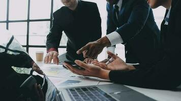 Financial analysts analyze business financial reports on a digital tablet planning investment project during a discussion at a meeting of corporate showing the results of their successful teamwork. video