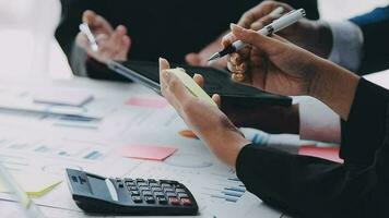 Financial analysts analyze business financial reports on a digital tablet planning investment project during a discussion at a meeting of corporate showing the results of their successful teamwork. video