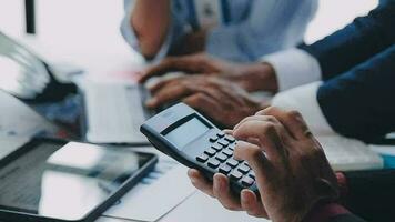 Financial analysts analyze business financial reports on a digital tablet planning investment project during a discussion at a meeting of corporate showing the results of their successful teamwork. video