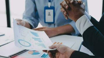Financial analysts analyze business financial reports on a digital tablet planning investment project during a discussion at a meeting of corporate showing the results of their successful teamwork. video