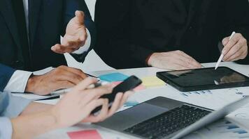 Financial analysts analyze business financial reports on a digital tablet planning investment project during a discussion at a meeting of corporate showing the results of their successful teamwork. video