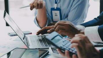 Financial analysts analyze business financial reports on a digital tablet planning investment project during a discussion at a meeting of corporate showing the results of their successful teamwork. video