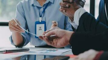 Financial analysts analyze business financial reports on a digital tablet planning investment project during a discussion at a meeting of corporate showing the results of their successful teamwork. video