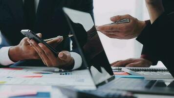 Financial analysts analyze business financial reports on a digital tablet planning investment project during a discussion at a meeting of corporate showing the results of their successful teamwork. video